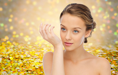 Image showing woman smelling perfume from wrist of her hand