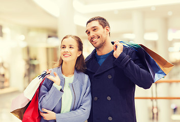 Image showing happy young couple with shopping bags in mall