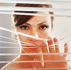 Image showing woman observes through blinds