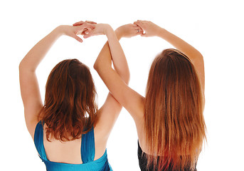 Image showing Two girls with there hands up.