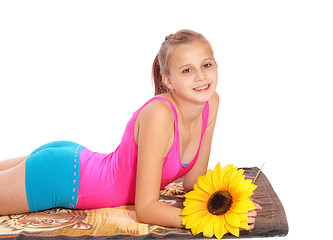 Image showing Young girl lying in bathing suit on a towel.