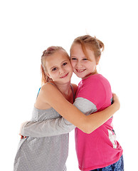 Image showing Smiling sisters hugging each other.