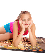 Image showing Closeup of young girl lying in bathing suit on floor.