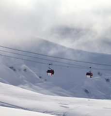 Image showing Gondola lifts and off-piste slope in mist