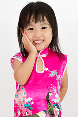 Image showing Chinese Little Girl wearing Cheongsam with greeting gesture