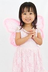 Image showing Chinese little girl wearing butterfly custome with praying gestu