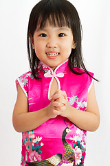 Image showing Chinese Little Girl wearing Cheongsam with greeting gesture