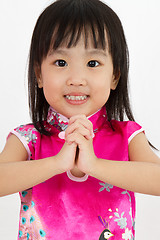 Image showing Chinese Little Girl wearing Cheongsam with greeting gesture