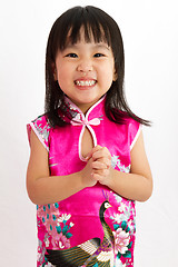 Image showing Chinese Little Girl wearing Cheongsam with greeting gesture