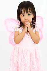 Image showing Chinese little girl wearing butterfly custome with praying gestu