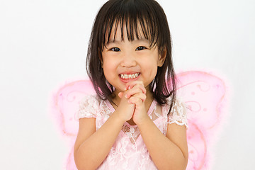 Image showing Chinese little girl wearing butterfly custome with praying gestu