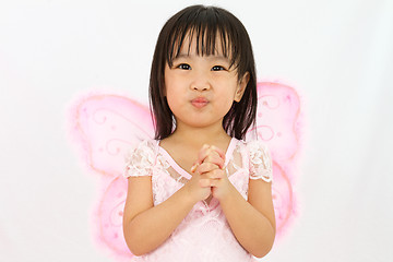 Image showing Chinese little girl wearing butterfly custome with praying gestu