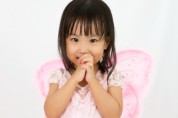 Image showing Chinese little girl wearing butterfly custome with praying gestu