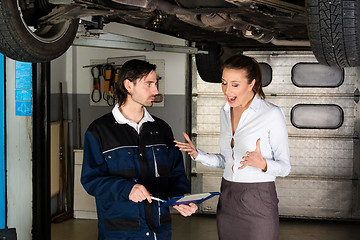 Image showing Car mechanic with angry female customer