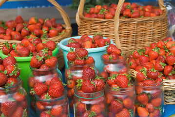 Image showing Strawberry collected in jar, buckets and baskets