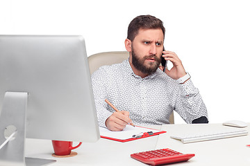 Image showing Portrait of businessman talking on mobile phone in office