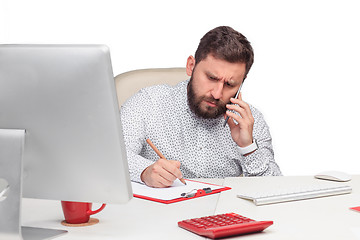 Image showing Portrait of businessman talking on mobile phone in office