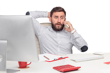 Image showing Portrait of businessman talking on mobile phone in office