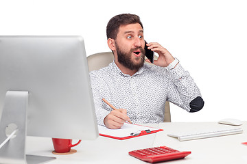 Image showing Portrait of businessman talking on mobile phone in office