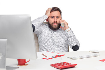 Image showing Portrait of businessman talking on mobile phone in office