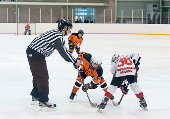 Image showing Puck playing between players of ice-hockey teams