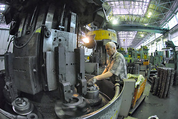 Image showing Elderly worker watches on milling machine work