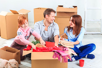 Image showing The happy family  at repair and relocation