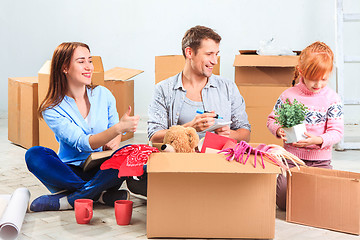 Image showing The happy family  at repair and relocation