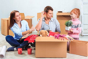 Image showing The happy family  at repair and relocation