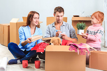 Image showing The happy family  at repair and relocation