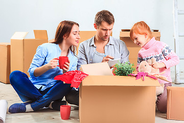 Image showing The happy family  during repair and relocation