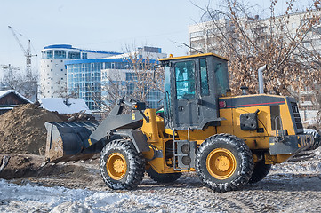 Image showing Tractor removes debris from building demolition