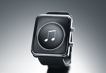 Image showing close up of black smart watch with music note icon