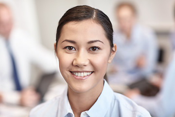 Image showing group of smiling businesspeople meeting in office