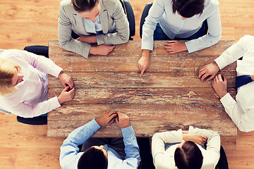 Image showing close up of business team sitting at table