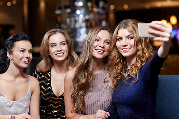 Image showing women with smartphone taking selfie at night club