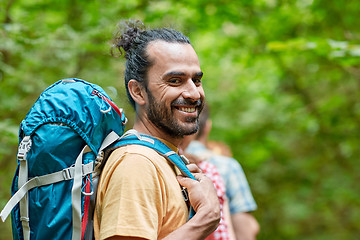 Image showing group of smiling friends with backpacks hiking