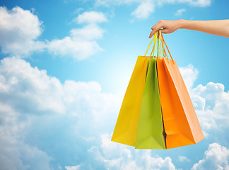 Image showing close up of hand holding shopping bags