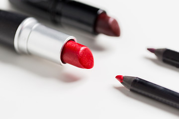 Image showing close up of two open lipsticks and lip pencils