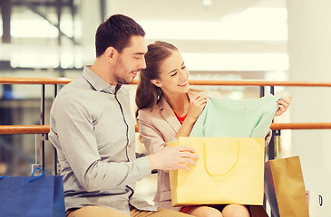 Image showing happy young couple with shopping bags in mall