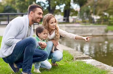 Image showing happy family walking in summer park