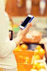 Image showing close up of woman with food basket in market