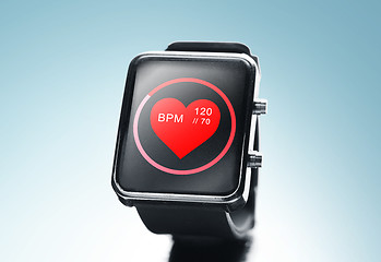 Image showing close up of black smart watch with heart beat icon