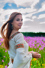 Image showing Beautiful woman relaxing on meadow with flowers