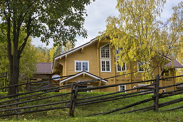 Image showing Big yellow rural wooden house in autumn