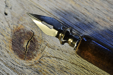 Image showing closeup of fountain pen on wooden 