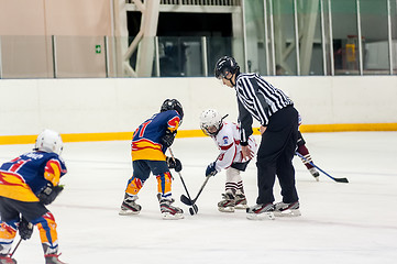 Image showing Puck playing between players of ice-hockey teams