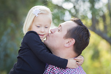 Image showing Father Kissing Adorable Little Girl Outdoors