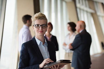 Image showing business woman  at office with tablet  in front  as team leader