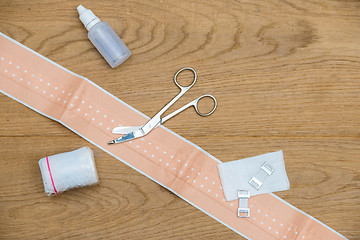 Image showing Medical Bandage And Scissors On Wooden Table